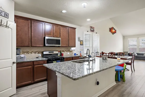 a kitchen with a stove a sink and a refrigerator