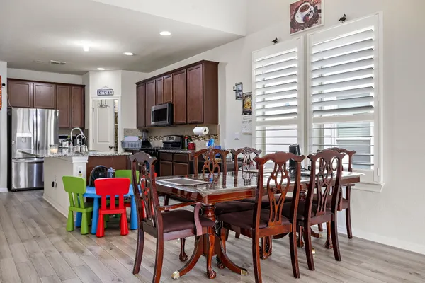 a view of a dining room with furniture and wooden floor