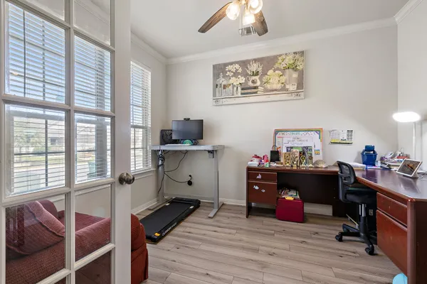 a view of a workspace with furniture and a window