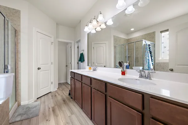 a bathroom with a double vanity sink and a mirror
