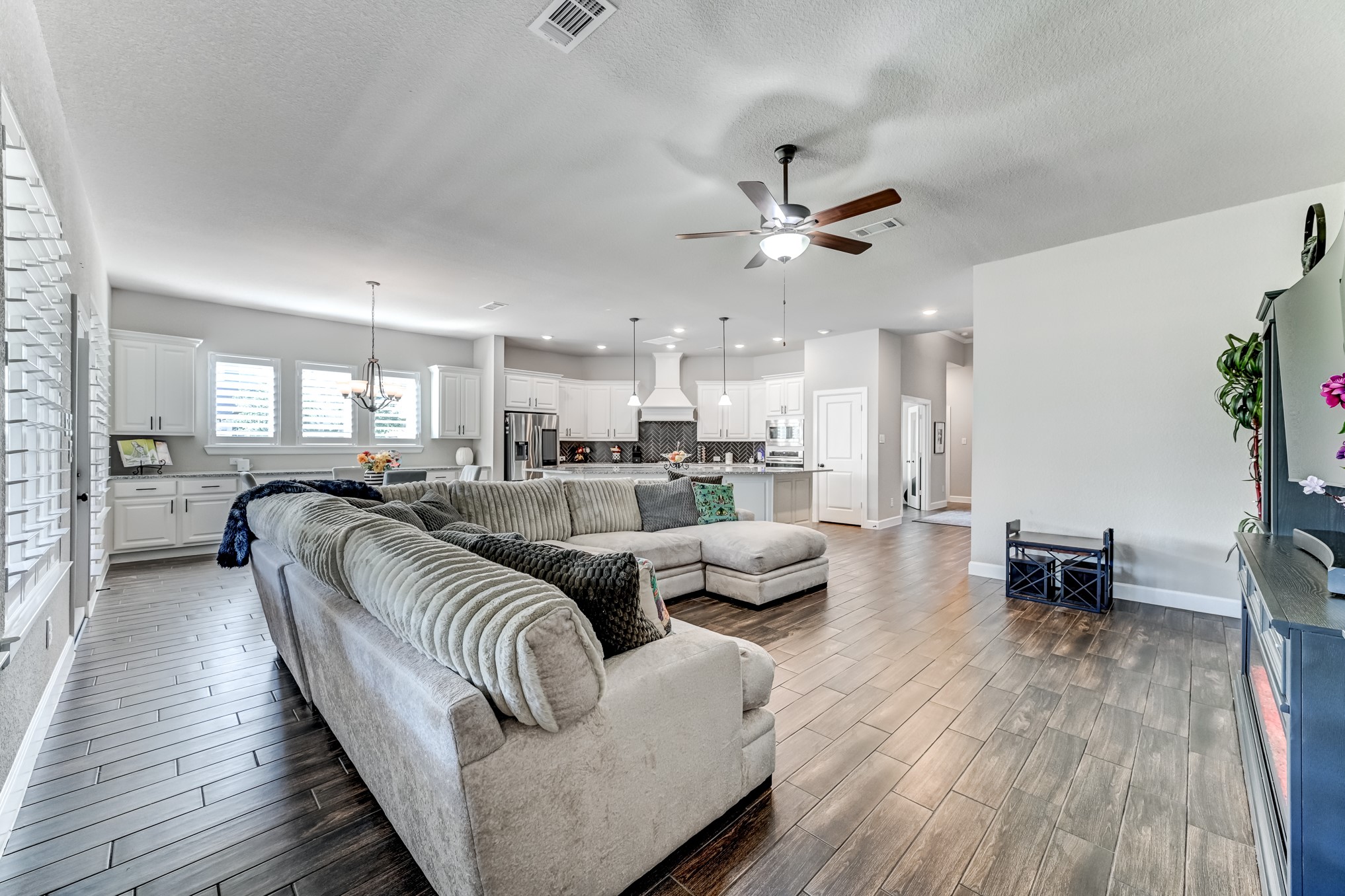 404 Summit Ridge Court Conroe, TX 77318 - Photo 19 of 50 a living room with furniture kitchen view and a wooden floor