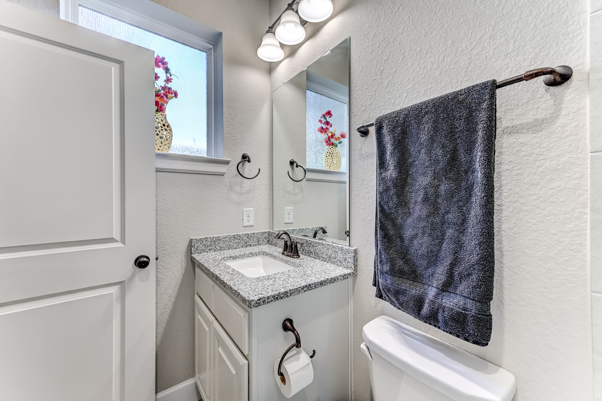 404 Summit Ridge Court Conroe, TX 77318 - Photo 30 of 50 a bathroom with a granite countertop sink a toilet and shower curtain