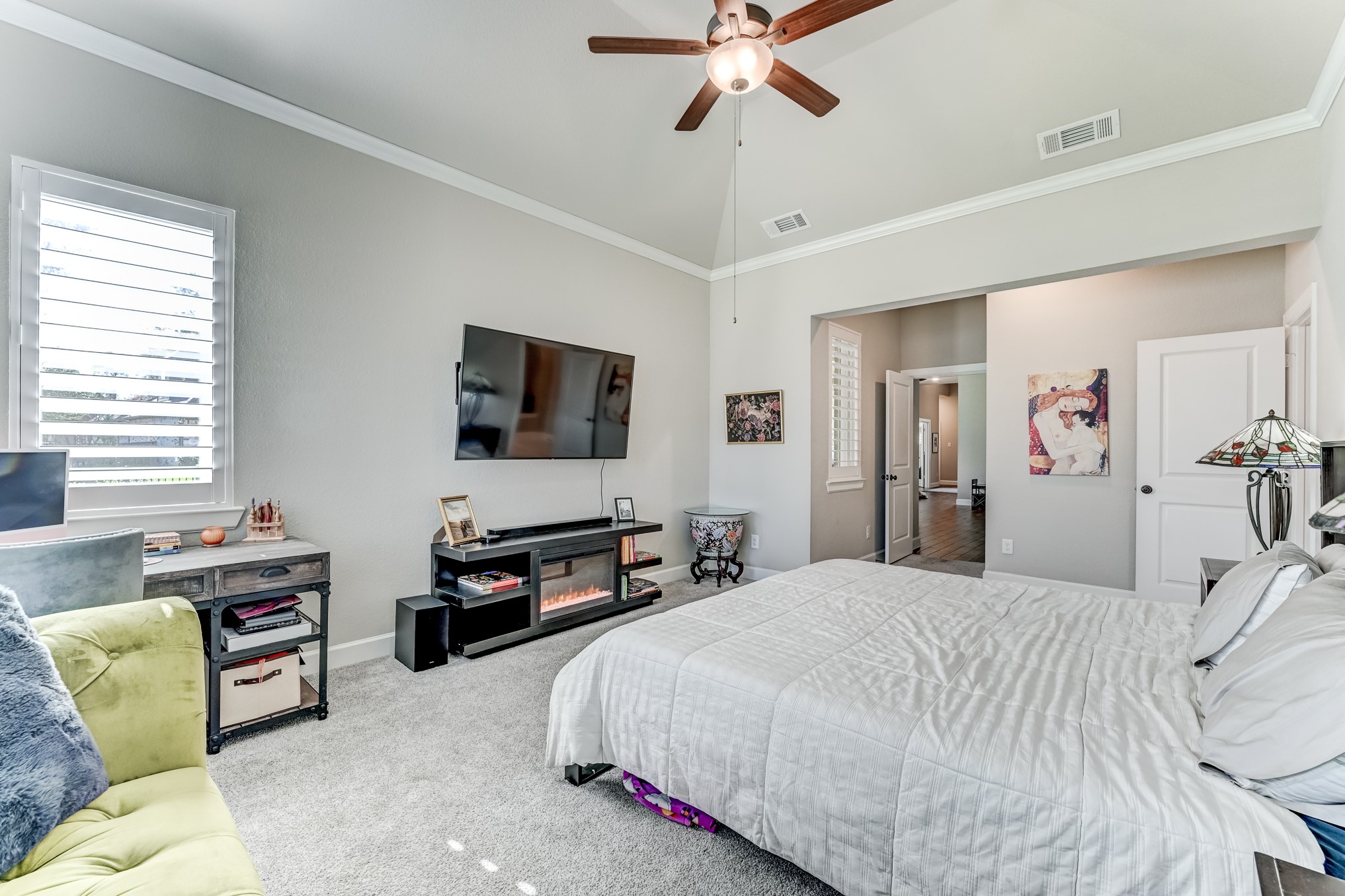 404 Summit Ridge Court Conroe, TX 77318 - Photo 32 of 50 a bedroom with a bed couch and a flat screen tv