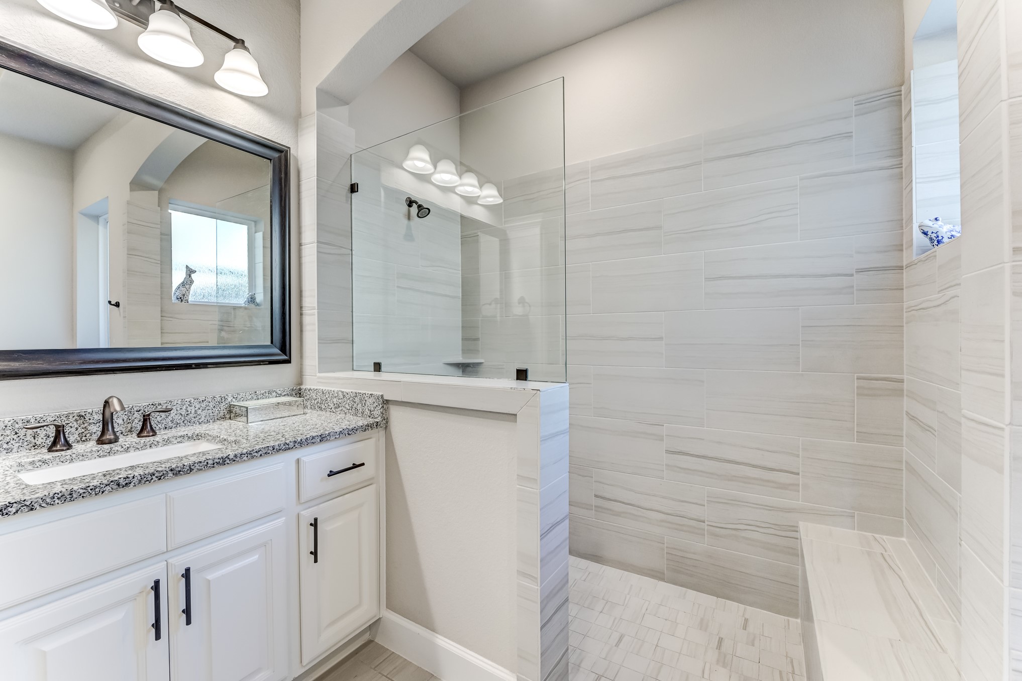 404 Summit Ridge Court Conroe, TX 77318 - Photo 38 of 50 a bathroom with a granite countertop sink a mirror and a shower