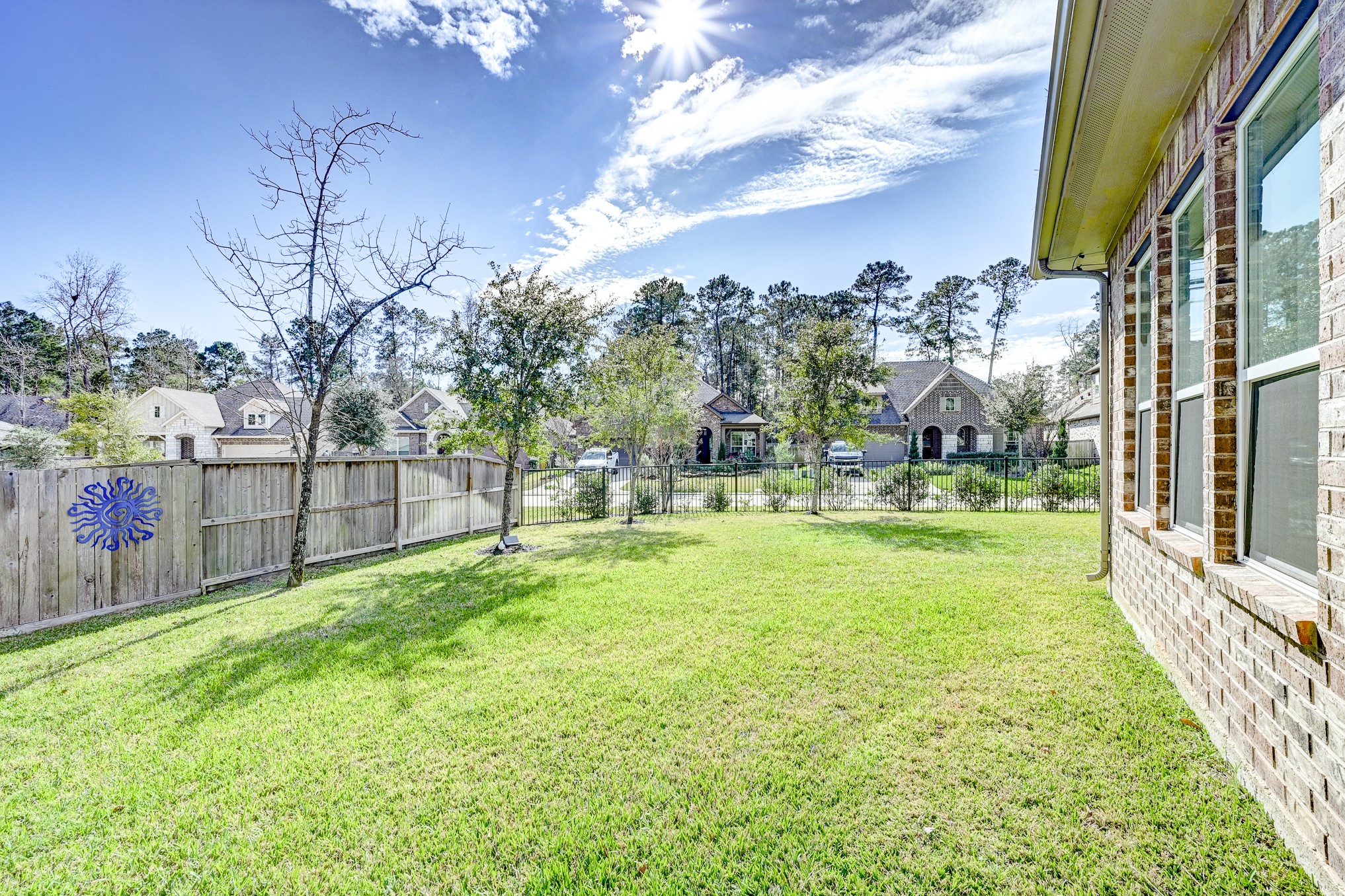 404 Summit Ridge Court Conroe, TX 77318 - Photo 46 of 50 a view of a garden with a building in the background