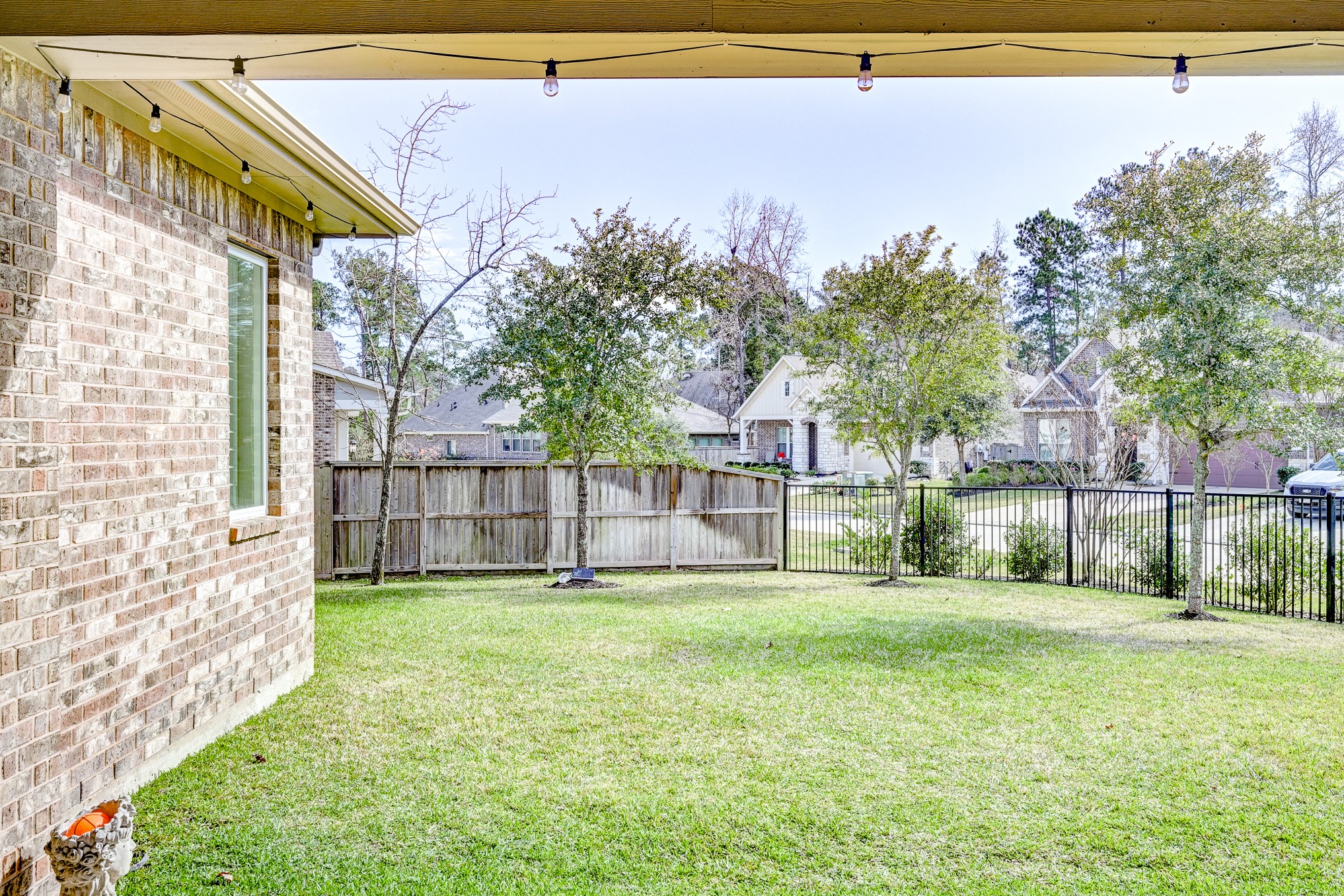 404 Summit Ridge Court Conroe, TX 77318 - Photo 47 of 50 a view of a house with a yard and sitting area