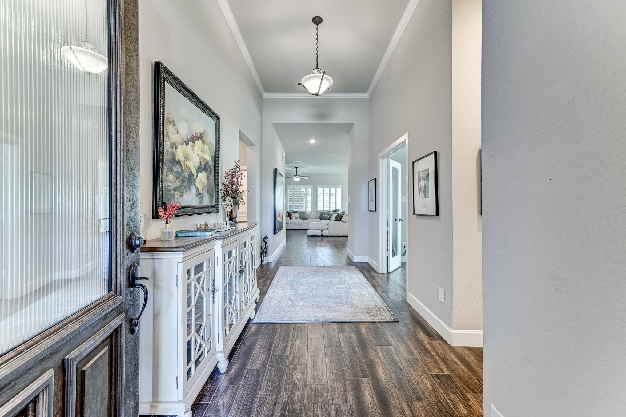 404 Summit Ridge Court Conroe, TX 77318 - Photo 5 of 50 a view of a hallway with wooden floor and staircase