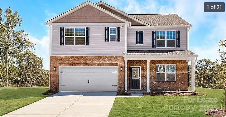 1365 Secrest Cmns Drive Monroe, NC 28112 - Photo 1 of 8 a front view of a house with a yard and garage