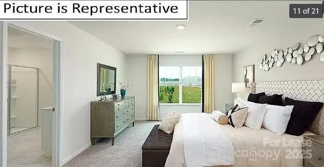 a bedroom with a bed and a large window