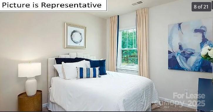 1365 Secrest Cmns Drive Monroe, NC 28112 - Photo 7 of 8 a bedroom with a bed and painting on the wall