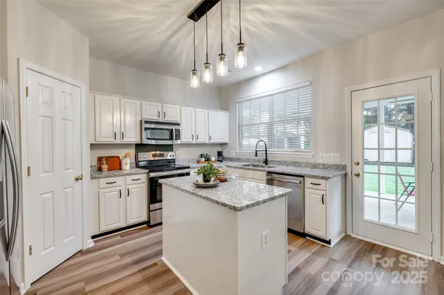 a bathroom with a granite countertop toilet sink and mirror