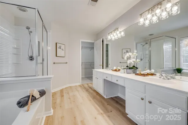 a bathroom with double vanity and a mirror