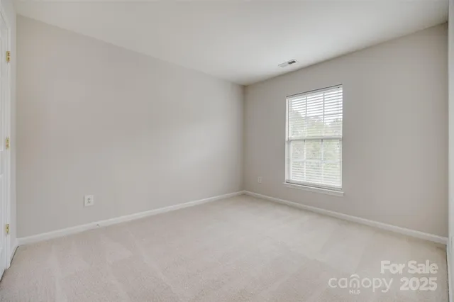 a view of a patio with a table chairs and a yard