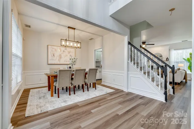 a living room with furniture a fireplace and a potted plant