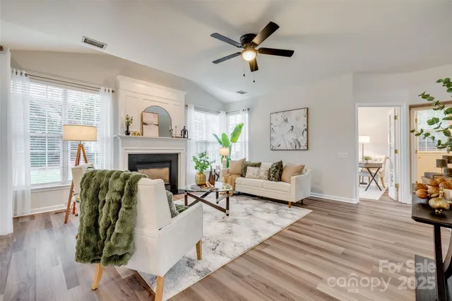 a living room with furniture and a view of kitchen