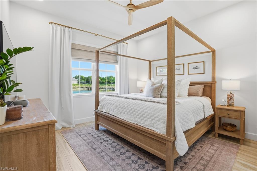 6975 Saona Court Naples, FL 34113 - Photo 12 of 30 a bed sitting in a bedroom next to a window