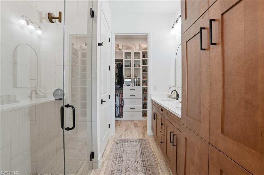 6975 Saona Court Naples, FL 34113 - Photo 14 of 30 a bathroom with a shower