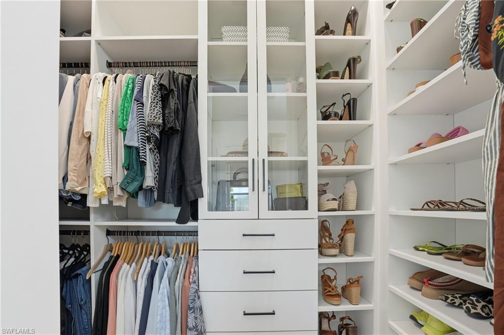 6975 Saona Court Naples, FL 34113 - Photo 15 of 30 a view of walk in closet with clothes and shoes