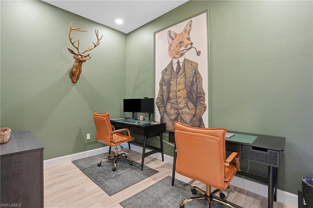 6975 Saona Court Naples, FL 34113 - Photo 16 of 30 a workspace with furniture and screen on the wall