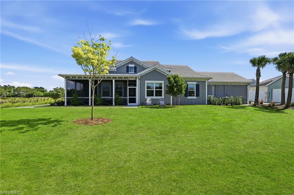 6975 Saona Court Naples, FL 34113 - Photo 28 of 30 a front view of a house with a yard