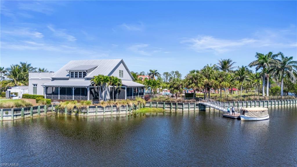 6975 Saona Court Naples, FL 34113 - Photo 30 of 30 a view of a lake with house