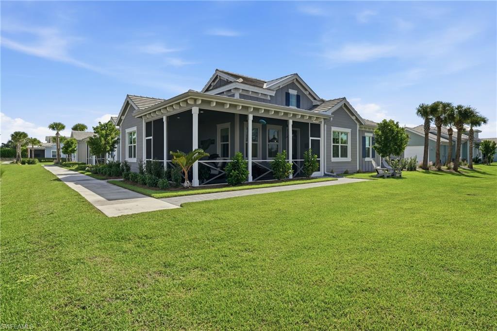 6975 Saona Court Naples, FL 34113 - Photo 3 of 30 a view of a big house with a big yard and potted plants