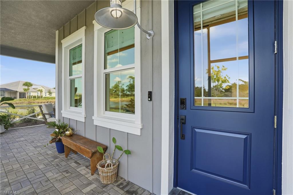 6975 Saona Court Naples, FL 34113 - Photo 4 of 30 a room with painting on the wall and a window