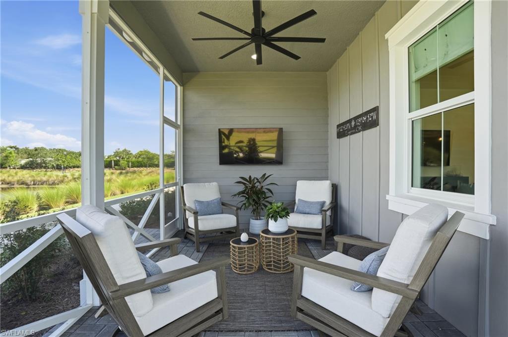 6975 Saona Court Naples, FL 34113 - Photo 5 of 30 a living room with furniture and a large window