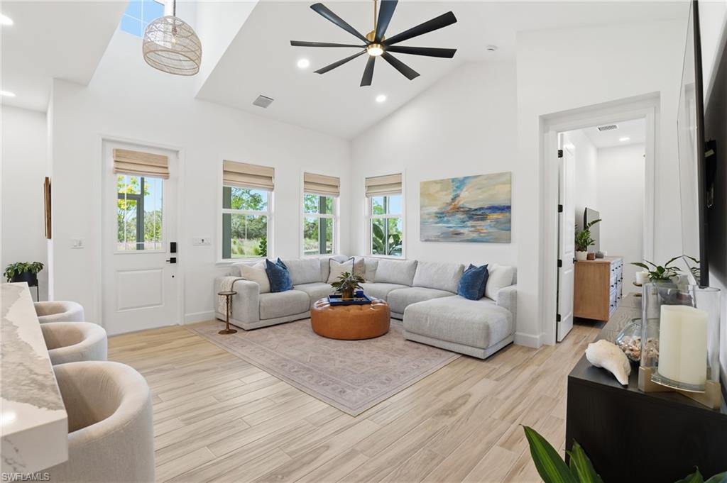 6975 Saona Court Naples, FL 34113 - Photo 10 of 30 a living room with furniture and a large window