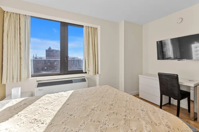 a bedroom with a bed and a chair