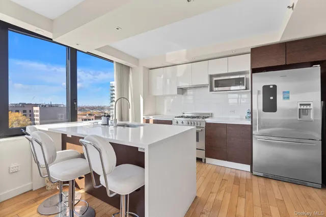 a very nice looking living room with a large window and wooden floor