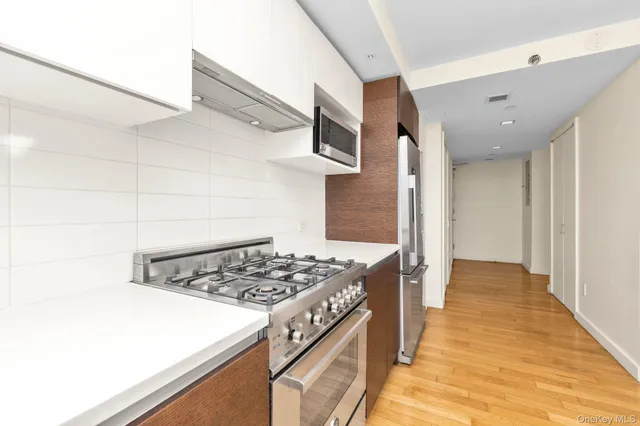 a kitchen with a stove a sink and a refrigerator