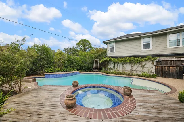 a view of swimming pool with outdoor seating and plants