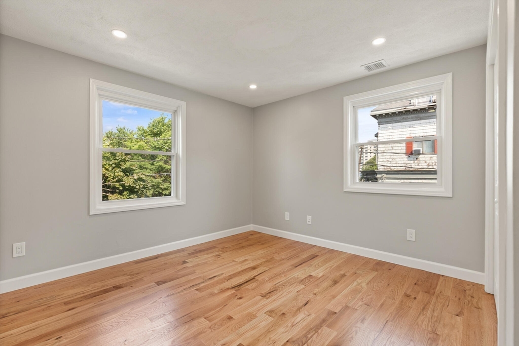 80 Newhall Street Lynn, MA 01902 - Photo 11 of 16 a room with a wooden floor and a window