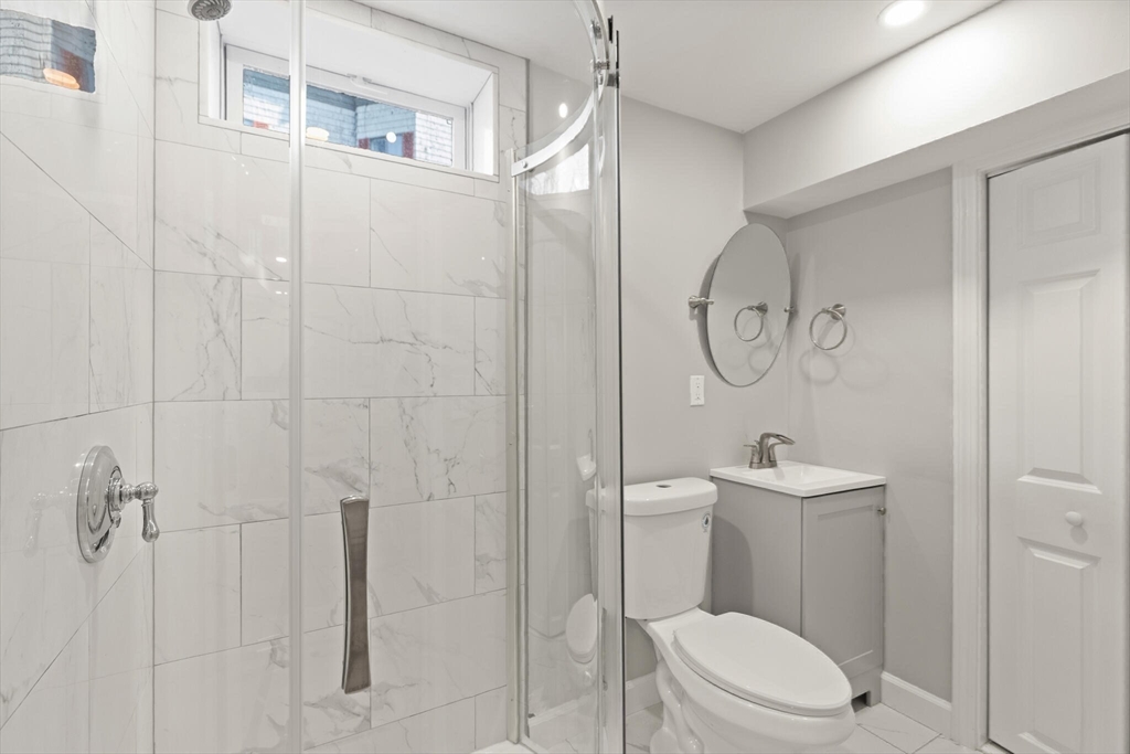 80 Newhall Street Lynn, MA 01902 - Photo 15 of 16 a bathroom with a toilet a sink and shower