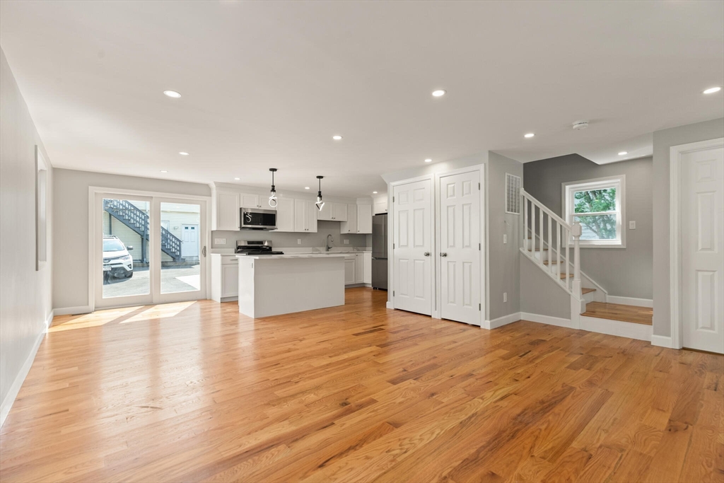 80 Newhall Street Lynn, MA 01902 - Photo 2 of 16 a view of a kitchen with a sink and dishwasher a refrigerator with wooden floor