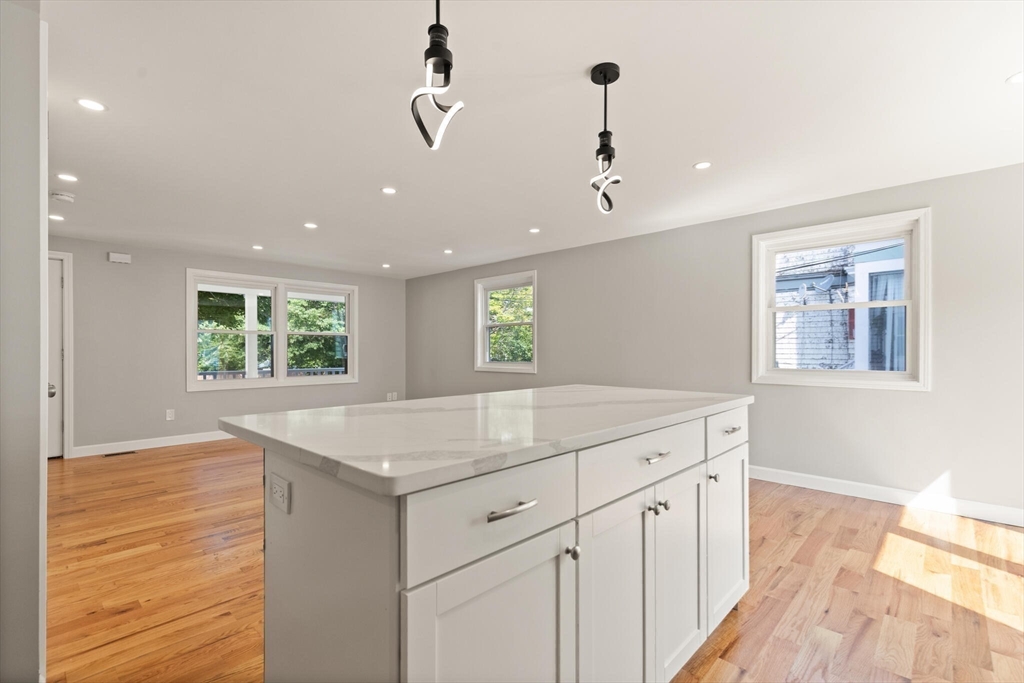 80 Newhall Street Lynn, MA 01902 - Photo 6 of 16 a kitchen with a sink chandelier and wooden floor