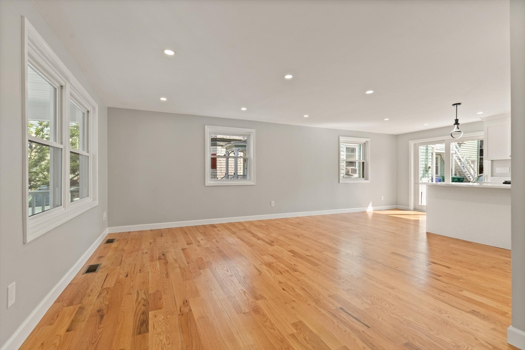 80 Newhall Street Lynn, MA 01902 - Photo 7 of 16 a view of empty room with wooden floor and fan