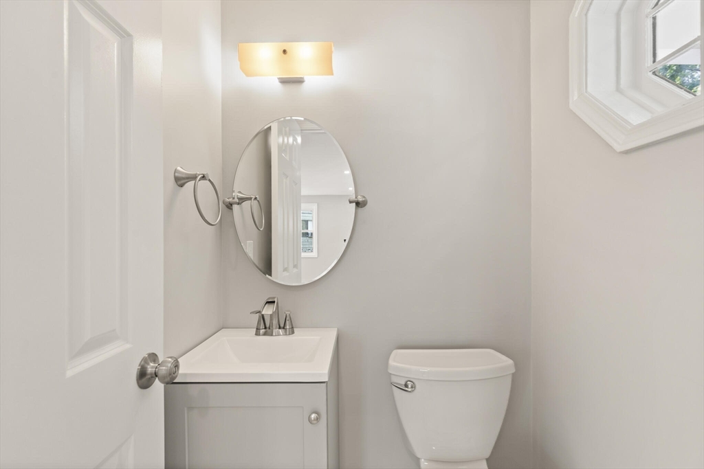 80 Newhall Street Lynn, MA 01902 - Photo 8 of 16 a bathroom with a toilet sink and mirror