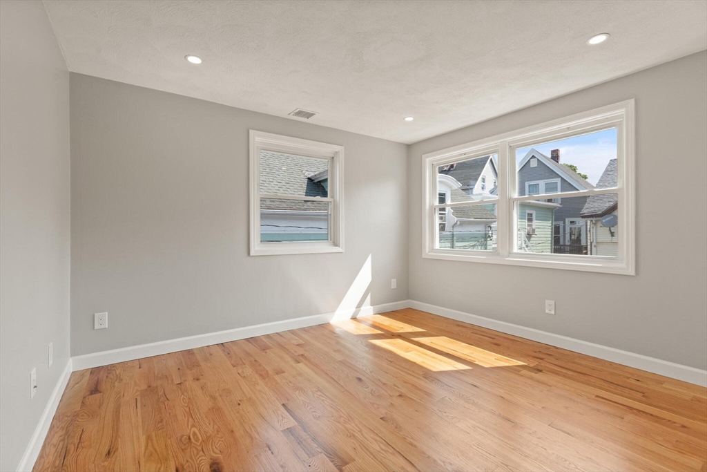 80 Newhall Street Lynn, MA 01902 - Photo 10 of 16 a view of empty room with wooden floor and fan