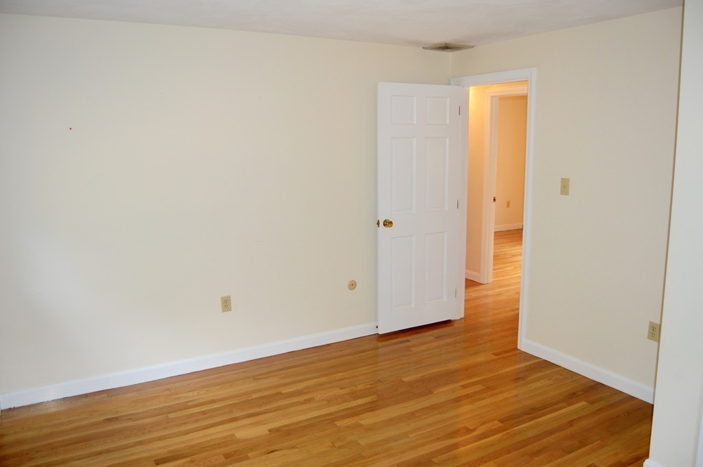 1 Rutgers Road Andover, MA 01810 - Photo 11 of 18 a view of an empty room with wooden floor