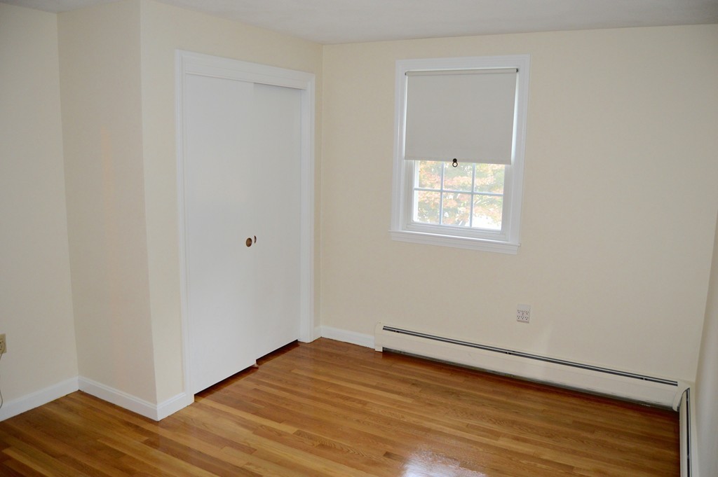 1 Rutgers Road Andover, MA 01810 - Photo 13 of 18 a view of an empty room with wooden floor and a window
