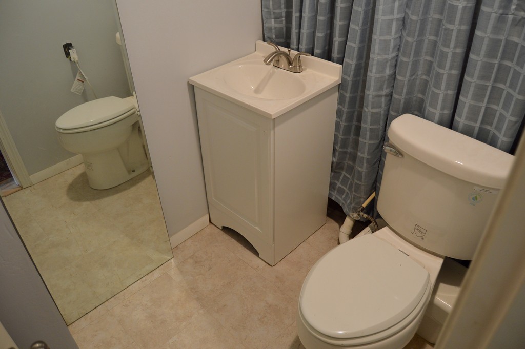 1 Rutgers Road Andover, MA 01810 - Photo 17 of 18 a white toilet sitting next to a bathroom sink