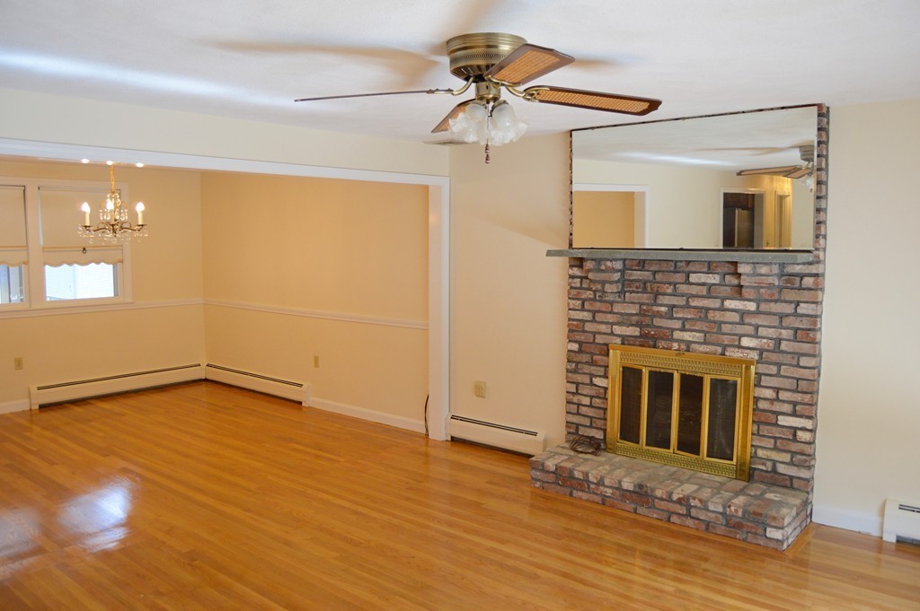 1 Rutgers Road Andover, MA 01810 - Photo 3 of 18 a view of an empty room with window and wooden floor