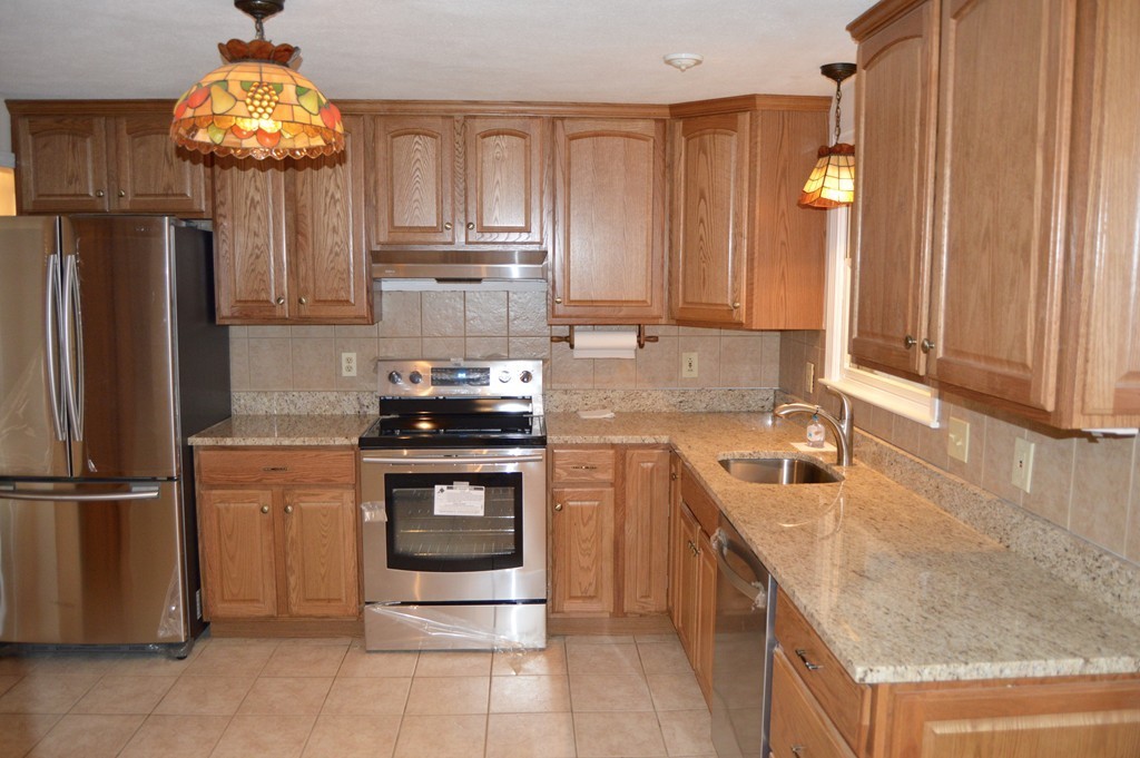 1 Rutgers Road Andover, MA 01810 - Photo 5 of 18 a kitchen with stainless steel appliances granite countertop a sink stove and refrigerator