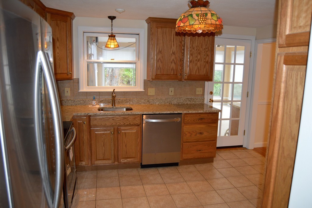 1 Rutgers Road Andover, MA 01810 - Photo 6 of 18 a kitchen with stainless steel appliances a stove a refrigerator and a window