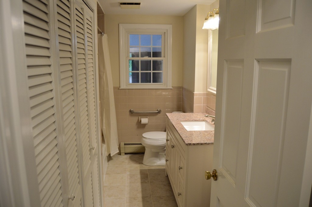 1 Rutgers Road Andover, MA 01810 - Photo 9 of 18 a bathroom with a toilet a sink and a mirror