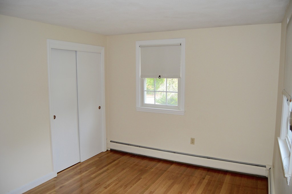 1 Rutgers Road Andover, MA 01810 - Photo 10 of 18 a view of an empty room with wooden floor and a window