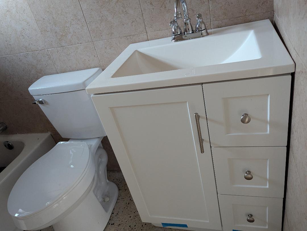 2736 Seneca Avenue Fort Pierce, FL 34946 - Photo 5 of 5 a white toilet sitting next to a sink