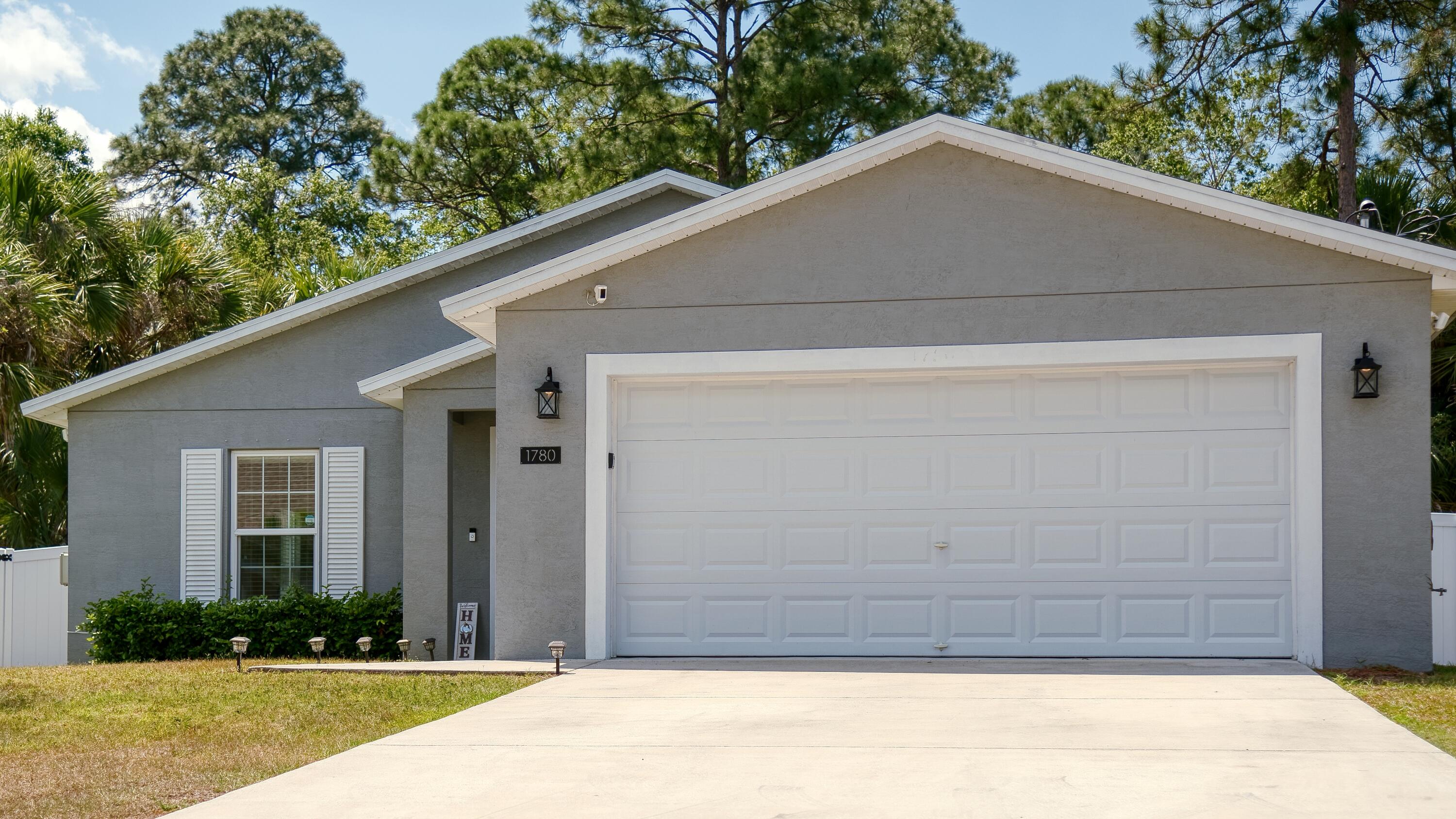 1780 Southwest Leafy Road Port St. Lucie, FL 34953 - Photo 1 of 30 a front view of a house with garage